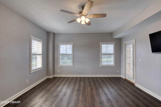 spare room featuring ceiling fan and dark hardwood / wood-style floors