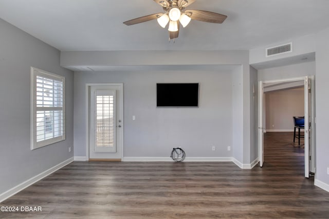 unfurnished living room with ceiling fan and dark hardwood / wood-style flooring