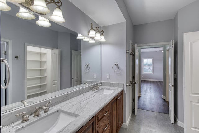 bathroom featuring vanity, hardwood / wood-style flooring, and a notable chandelier