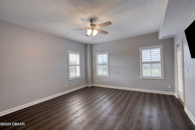 unfurnished room with ceiling fan, dark hardwood / wood-style floors, and plenty of natural light