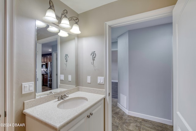 bathroom with a chandelier and vanity