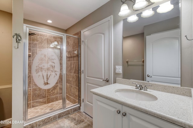 bathroom featuring vanity and a shower with shower door