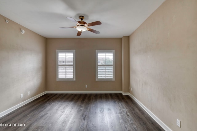 empty room with ceiling fan and dark hardwood / wood-style floors