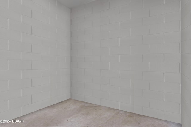 unfurnished room featuring concrete floors