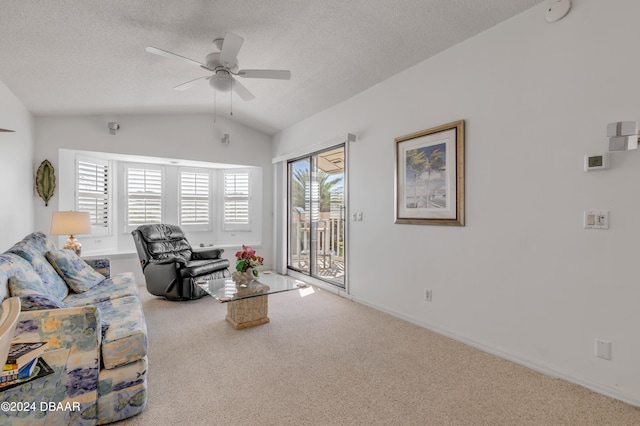 carpeted living room with a textured ceiling, plenty of natural light, lofted ceiling, and ceiling fan