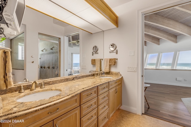 bathroom with lofted ceiling with beams, vanity, hardwood / wood-style flooring, and plenty of natural light