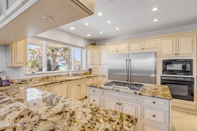 kitchen featuring black appliances and cream cabinets