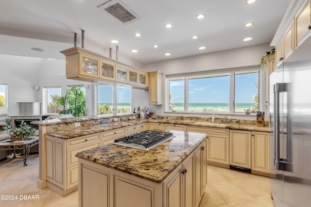 kitchen featuring stainless steel appliances, a center island, and light stone countertops