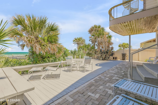 view of patio with a view of the beach and a water view