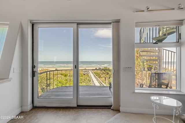 entryway with a wealth of natural light and a water view