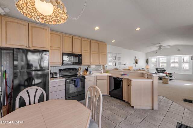 kitchen featuring lofted ceiling, kitchen peninsula, black appliances, light tile patterned flooring, and ceiling fan