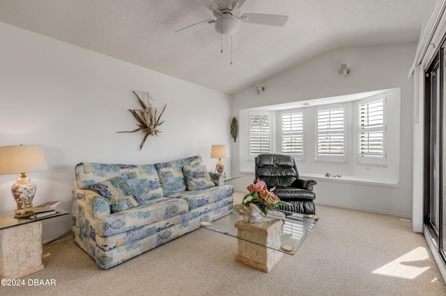 carpeted living room featuring ceiling fan, a textured ceiling, and lofted ceiling