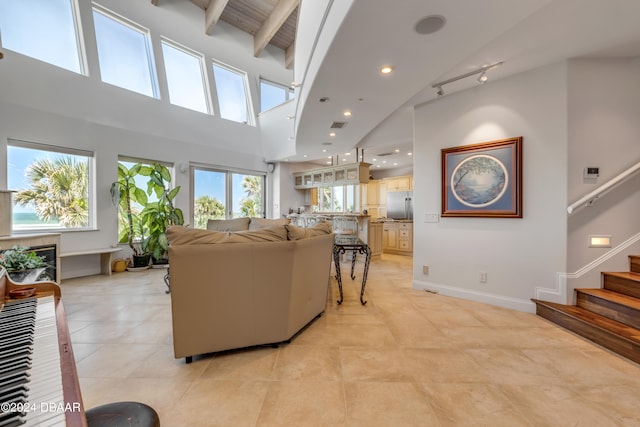 living room featuring high vaulted ceiling and beam ceiling