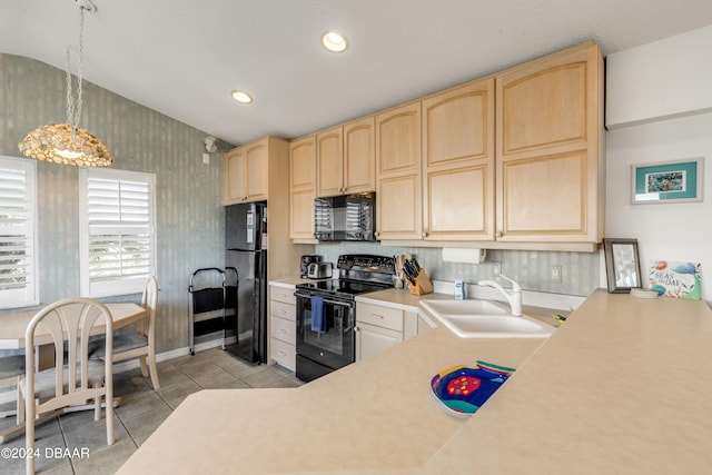 kitchen featuring hanging light fixtures, black appliances, sink, light tile patterned floors, and light brown cabinetry