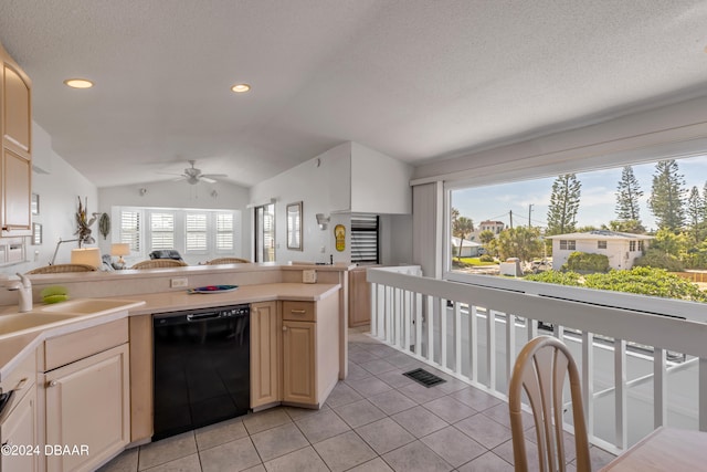 kitchen featuring sink, ceiling fan, light tile patterned floors, lofted ceiling, and black dishwasher