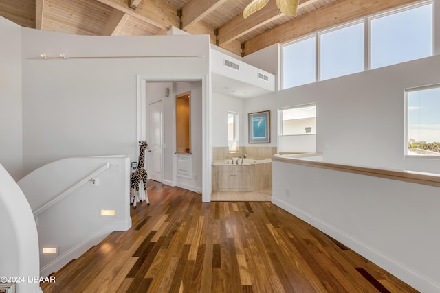 hall with high vaulted ceiling, wood ceiling, dark hardwood / wood-style floors, and beam ceiling