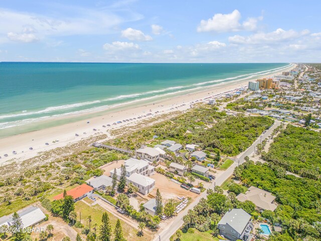 aerial view with a water view and a beach view