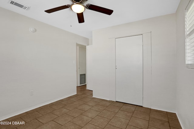 unfurnished bedroom with a closet and ceiling fan