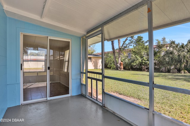 unfurnished sunroom with a wealth of natural light and lofted ceiling