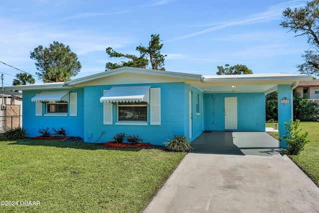 single story home with a carport and a front lawn