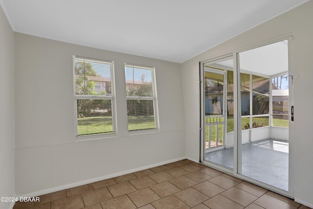 doorway with plenty of natural light and vaulted ceiling