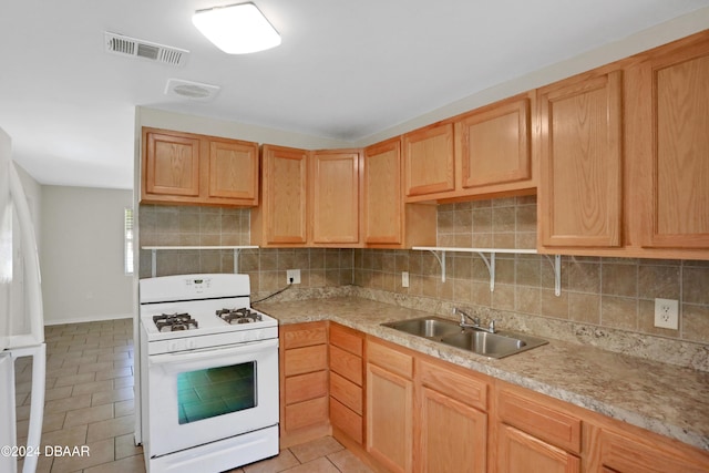 kitchen featuring white appliances, sink, light tile patterned flooring, and tasteful backsplash