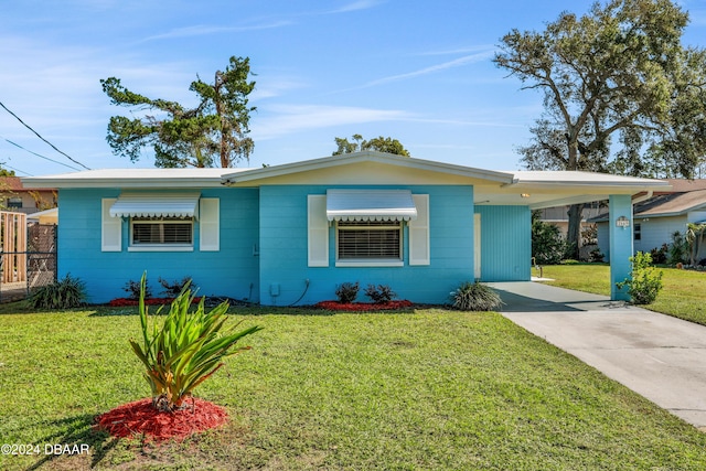 single story home with a front yard and a carport