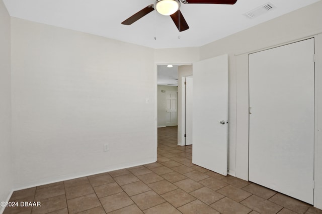 unfurnished bedroom featuring light tile patterned floors and ceiling fan