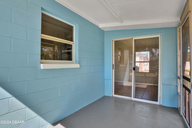 unfurnished sunroom featuring vaulted ceiling