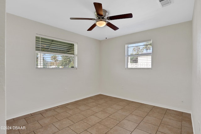 empty room featuring light tile patterned flooring and ceiling fan