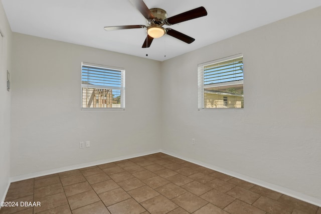 tiled spare room featuring ceiling fan