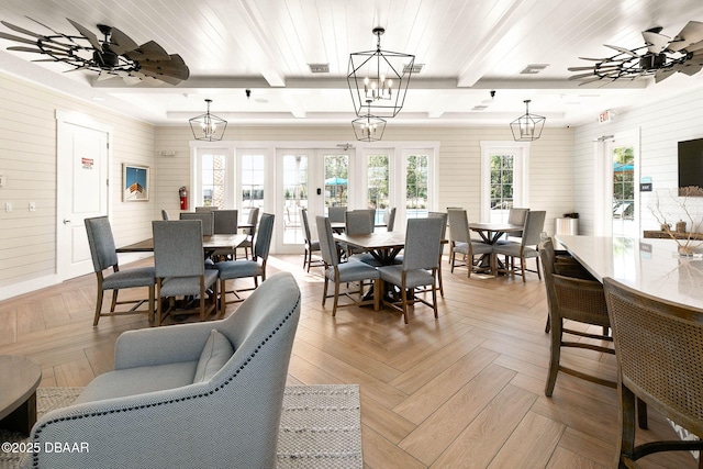 dining area featuring ceiling fan with notable chandelier, beam ceiling, and visible vents