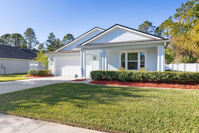 view of front facade with a garage, a front yard, driveway, and fence