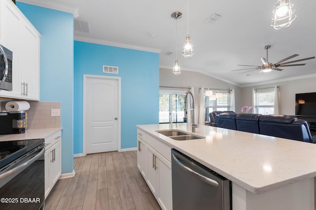 kitchen featuring visible vents, decorative backsplash, dishwasher, crown molding, and a sink