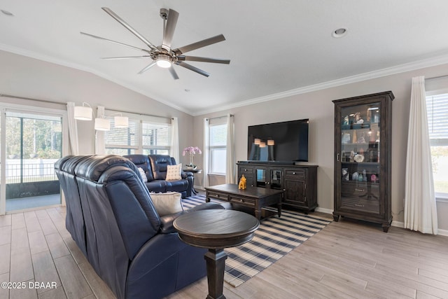 living room featuring crown molding, vaulted ceiling, and light wood-style flooring