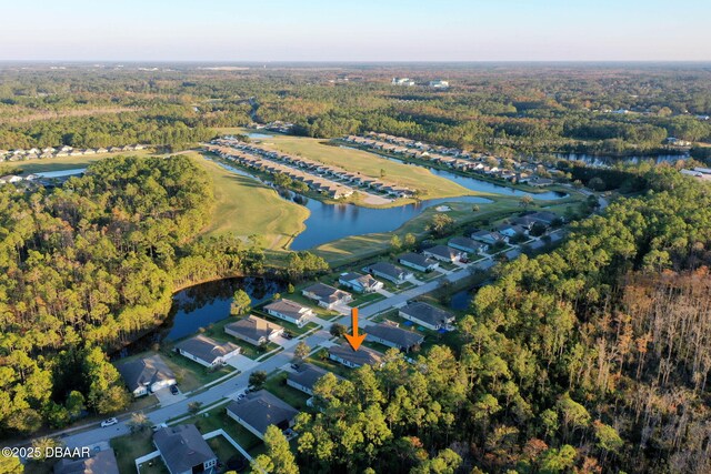 drone / aerial view featuring a water view and a forest view