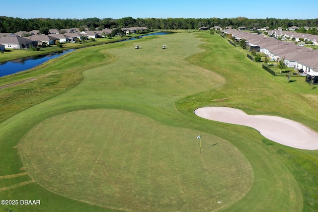 drone / aerial view featuring a water view, a residential view, and golf course view