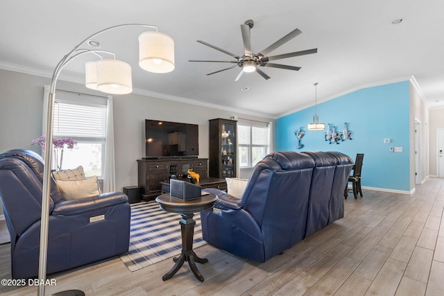 living room with light wood finished floors, vaulted ceiling, and crown molding