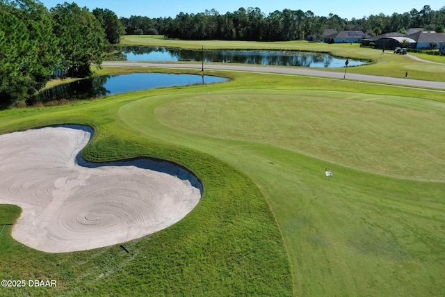 view of property's community featuring view of golf course, a water view, and a yard