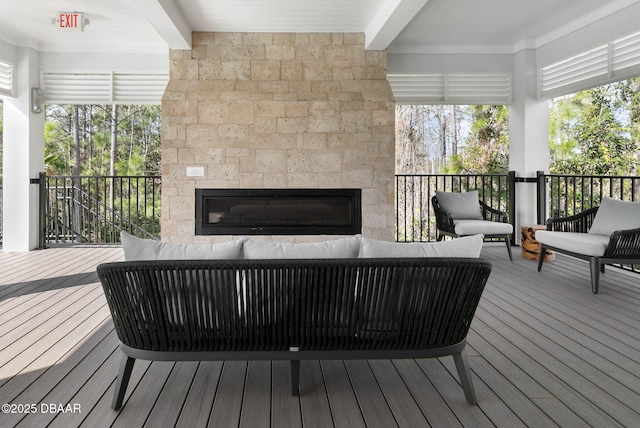 wooden deck featuring an outdoor living space with a fireplace