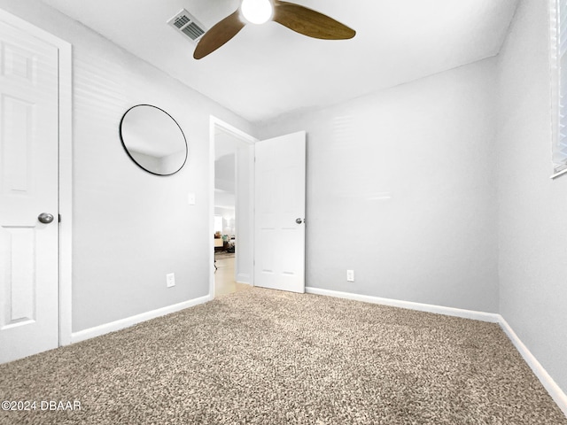 unfurnished bedroom featuring ceiling fan and carpet flooring