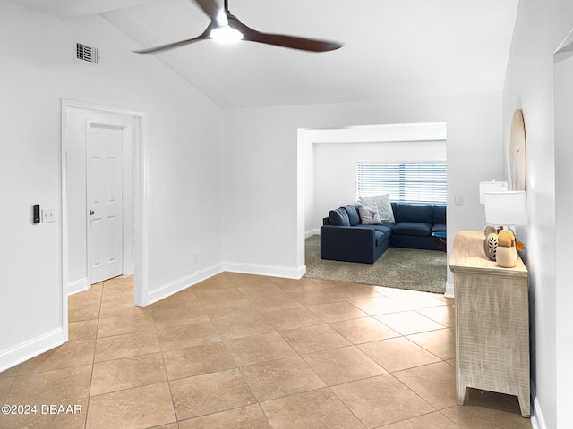 living room with ceiling fan, light carpet, and vaulted ceiling