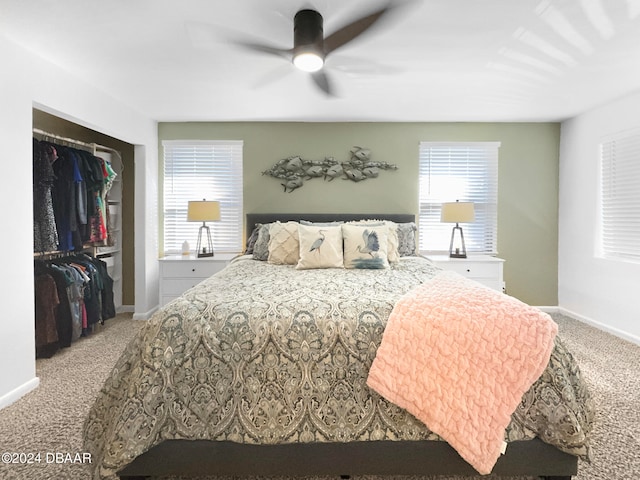 carpeted bedroom featuring ceiling fan and a closet