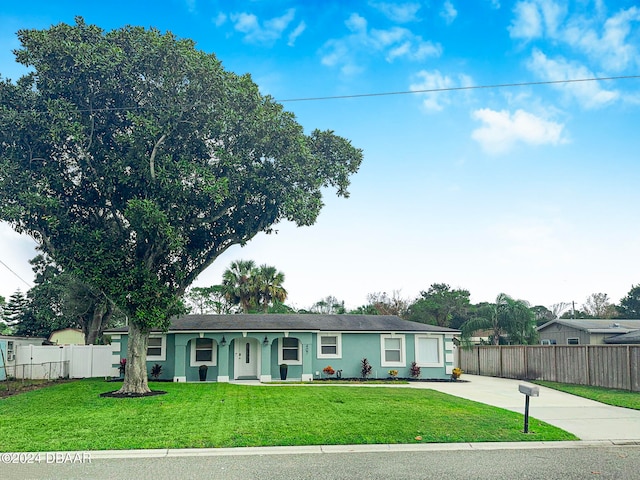 ranch-style home with a front lawn