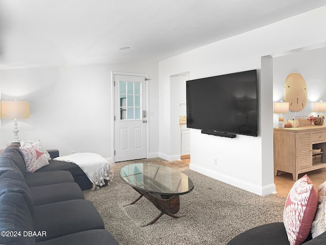 living room featuring light carpet and vaulted ceiling