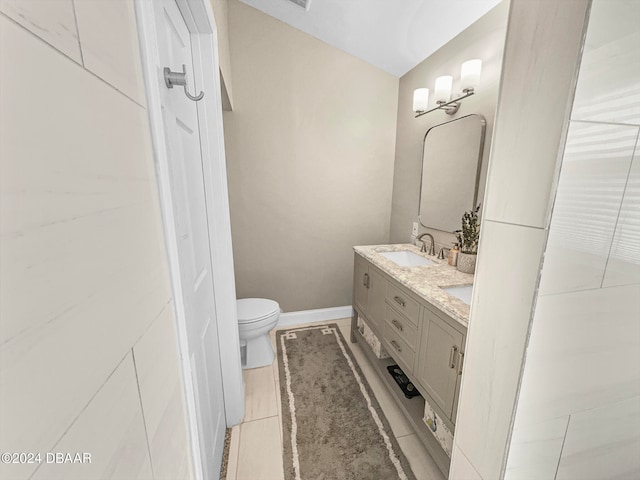 bathroom featuring vanity, tile patterned floors, and toilet