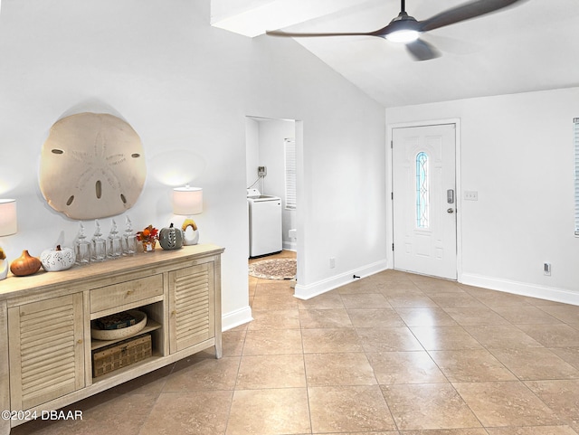 tiled foyer with washer / clothes dryer, vaulted ceiling, and ceiling fan