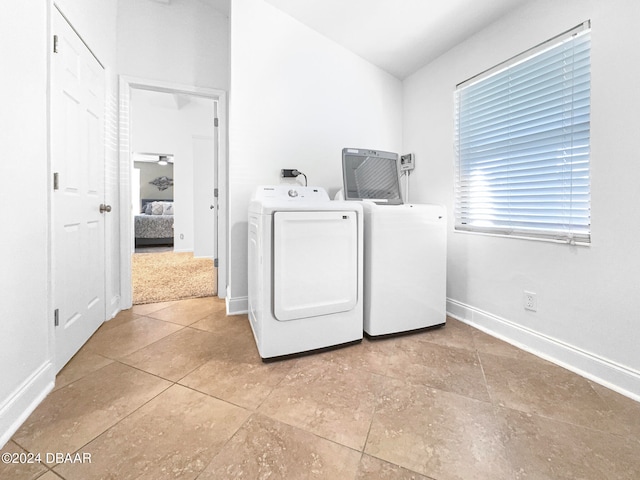 clothes washing area featuring separate washer and dryer