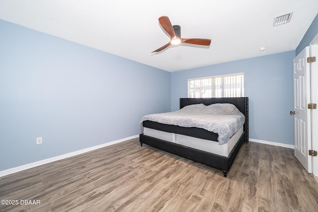 bedroom with dark wood-type flooring and ceiling fan