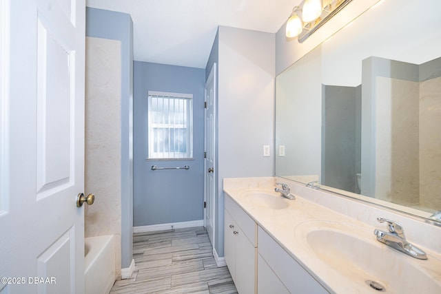 bathroom with a bath and vanity